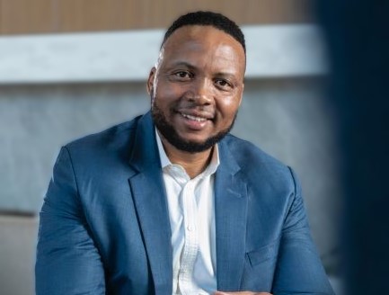 Portrait of Sello Matsobane in a blue suit.